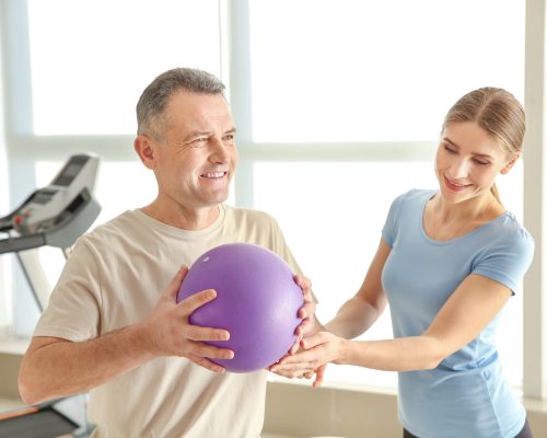 Physiotherapist working with mature patient in rehabilitation center Physiotherapist working with mature patient in rehabilitation center