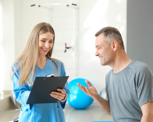 Physiotherapist working with mature patient in rehabilitation center Physiotherapist working with mature patient in rehabilitation center