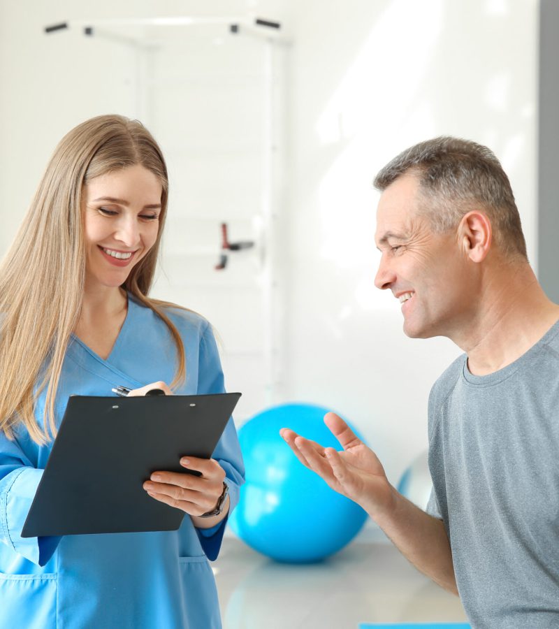 Physiotherapist working with mature patient in rehabilitation center Physiotherapist working with mature patient in rehabilitation center